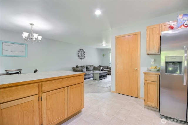 13502 215th Ave E, Bonney Lake, WA 98391 - kitchen with stainless steel refrigerator with ice dispenser, light countertops, a chandelier, light brown cabinets, and hanging light fixtures