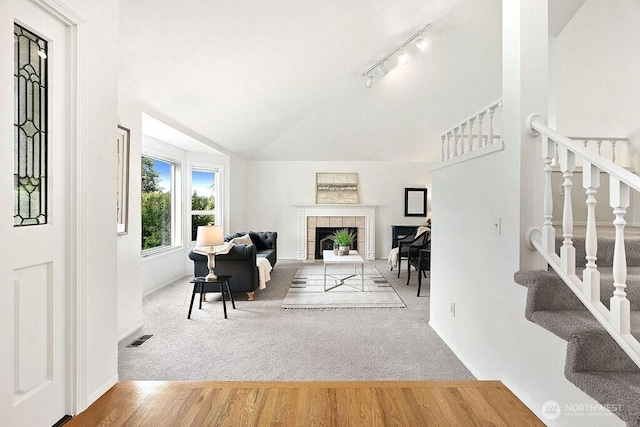 1112 SW 326th Pl, Federal Way, WA 98023 - living area with vaulted ceiling, wood finished floors, baseboards, stairway, and carpet