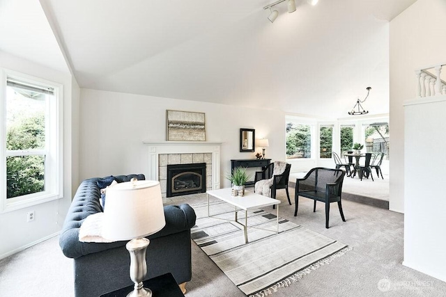 1112 SW 326th Pl, Federal Way, WA 98023 - living room featuring light colored carpet, plenty of natural light, lofted ceiling, a fireplace, and track lighting