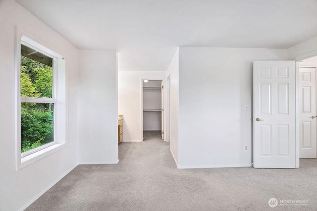 1112 SW 326th Pl, Federal Way, WA 98023 - unfurnished bedroom featuring light carpet, baseboards, a walk in closet, and a closet