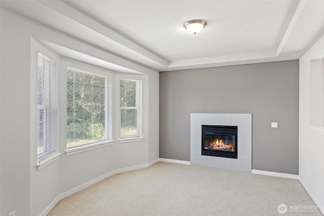 1120 156th Ave SE, Bellevue, WA 98007 - unfurnished living room featuring carpet flooring, a fireplace, a tray ceiling, and baseboards