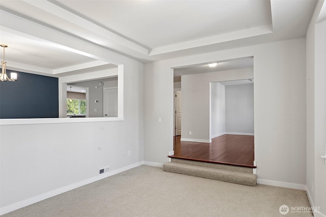 1120 156th Ave SE, Bellevue, WA 98007 - unfurnished room featuring a raised ceiling, baseboards, a chandelier, and carpet flooring