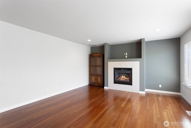 1120 156th Ave SE, Bellevue, WA 98007 - unfurnished living room featuring a tile fireplace, wood finished floors, baseboards, and recessed lighting