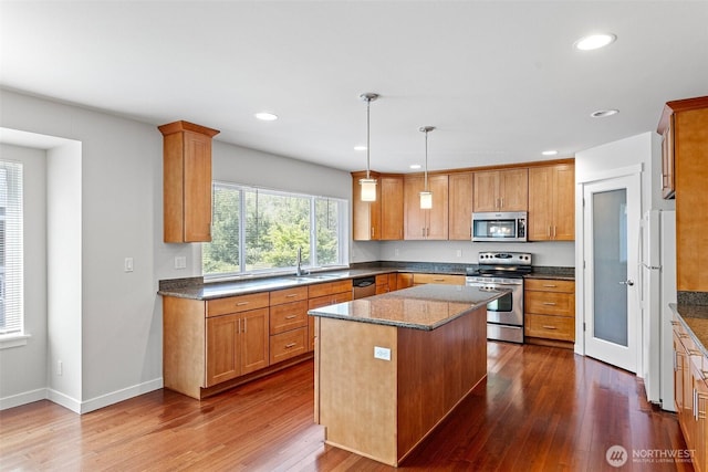 1120 156th Ave SE, Bellevue, WA 98007 - kitchen featuring appliances with stainless steel finishes, a sink, dark wood-type flooring, a center island, and recessed lighting