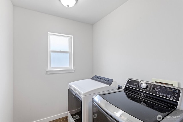 1120 156th Ave SE, Bellevue, WA 98007 - washroom with washing machine and clothes dryer and baseboards