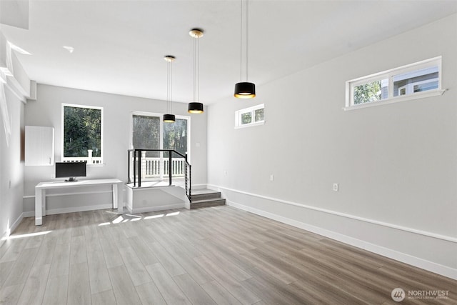 1120 156th Ave SE, Bellevue, WA 98007 - unfurnished living room featuring light wood-style floors, healthy amount of natural light, and baseboards