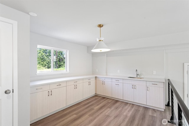 1120 156th Ave SE, Bellevue, WA 98007 - kitchen featuring a sink, light countertops, light wood-style floors, and pendant lighting