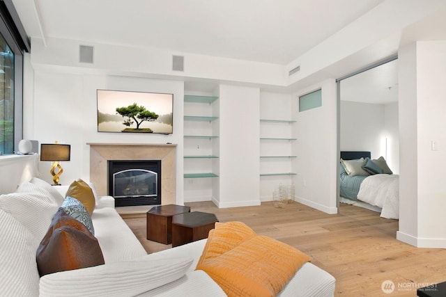 10650 NE 9th Pl Unit 3210, Bellevue, WA 98004 - living area with wood finished floors, a fireplace, baseboards, and built in features