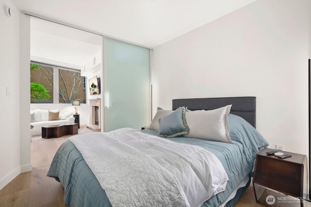 10650 NE 9th Pl Unit 3210, Bellevue, WA 98004 - bedroom featuring wood finished floors and baseboards