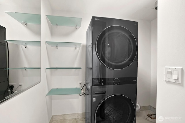 10650 NE 9th Pl Unit 3210, Bellevue, WA 98004 - washroom featuring stacked washer / drying machine, marble finish flooring, and baseboards