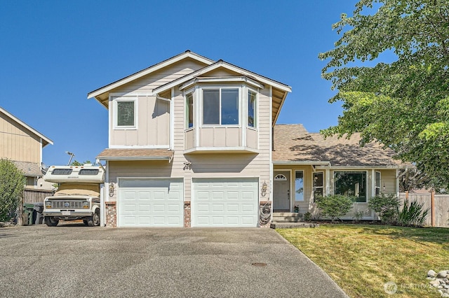 7116 193rd St E, Spanaway, WA 98387 - view of front of house with a garage, board and batten siding, driveway, and a shingled roof