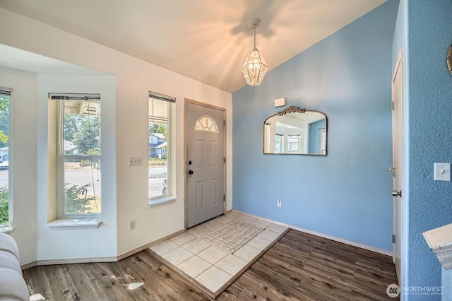 7116 193rd St E, Spanaway, WA 98387 - foyer entrance featuring a chandelier, wood finished floors, and lofted ceiling