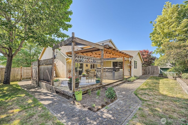 7116 193rd St E, Spanaway, WA 98387 - back of property with a hot tub, a fenced backyard, a deck, and a pergola