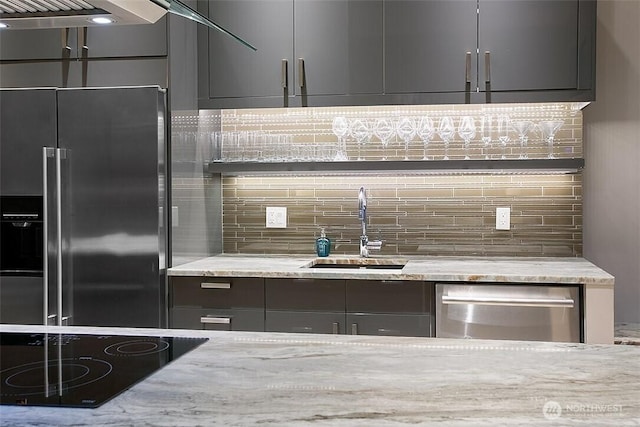 2021 1st Ave Unit G4, Seattle, WA 98121 - kitchen with a sink, dishwasher, high end fridge, black electric cooktop, and tasteful backsplash