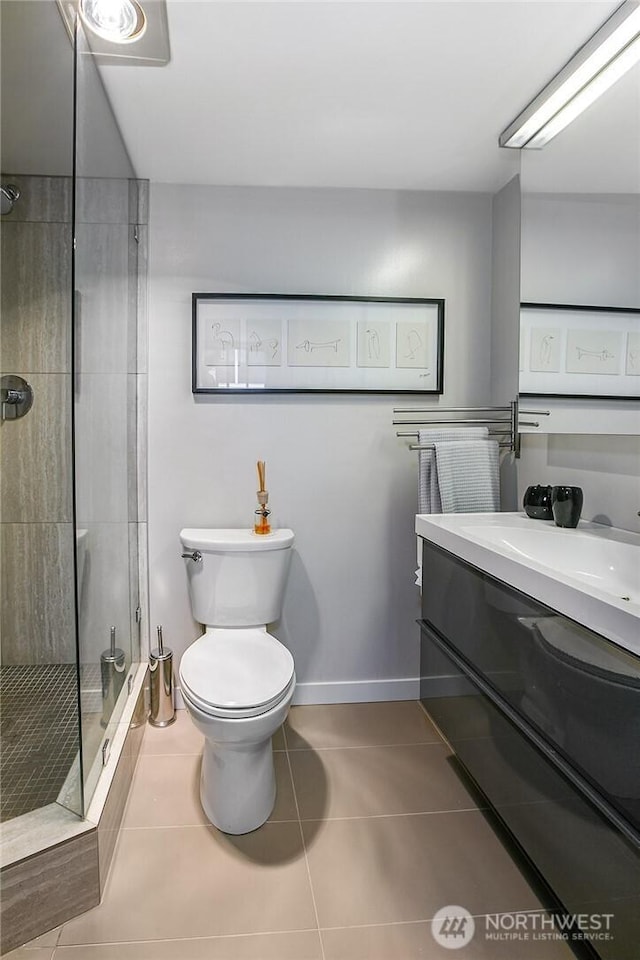 2021 1st Ave Unit G4, Seattle, WA 98121 - bathroom with tile patterned flooring, toilet, vanity, a shower stall, and baseboards