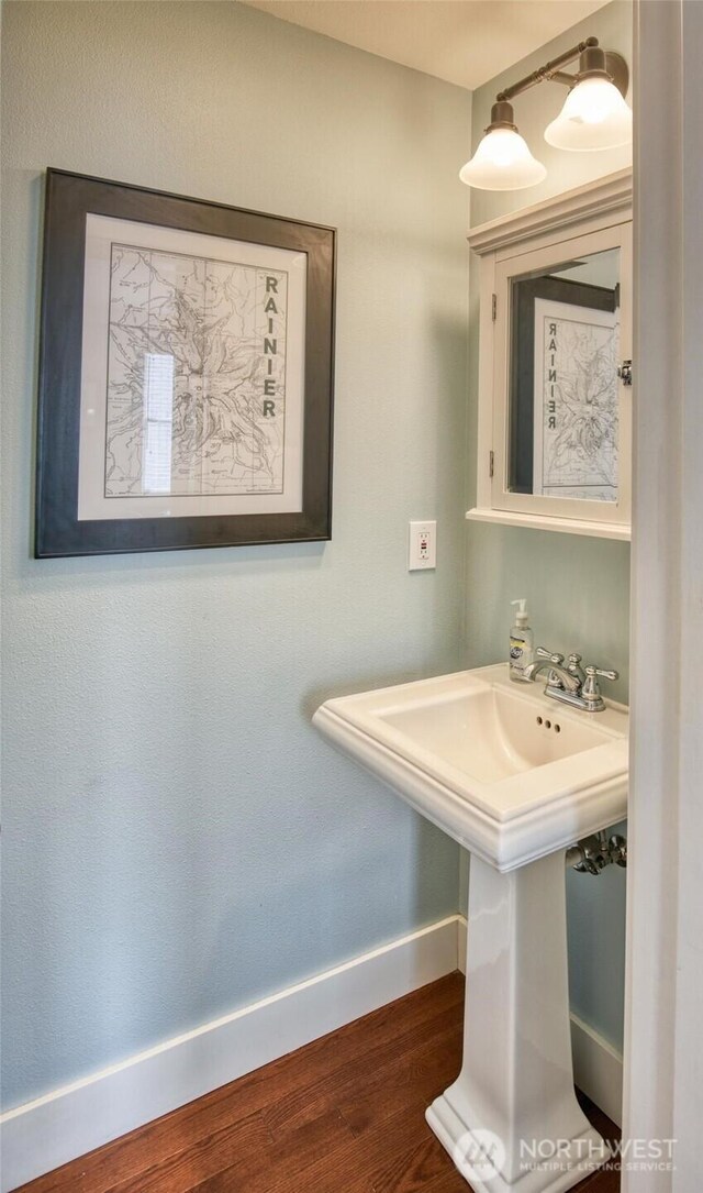38 W Myrtle Ln, Pacific Beach, WA 98571 - bathroom featuring baseboards, wood finished floors, and a sink