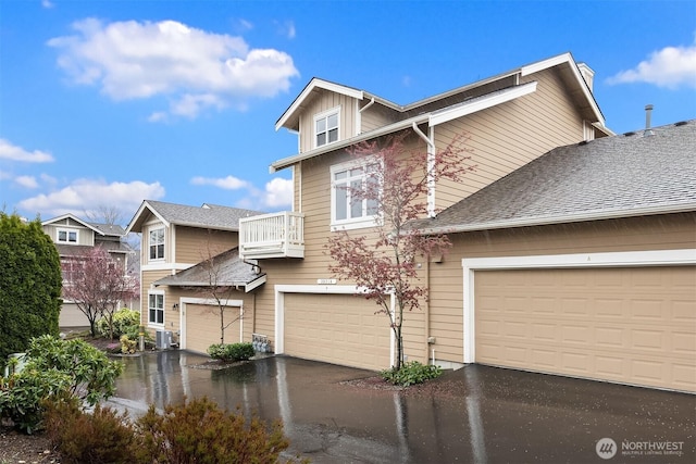 35314 SE Sequoia Pl Unit B, Snoqualmie, WA 98065 - view of front of house featuring a balcony, a garage, and driveway