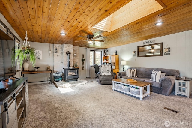 401 British Columbia Ave, Lynden, WA 98264 - living room featuring a wood stove, wood ceiling, carpet flooring, and ceiling fan