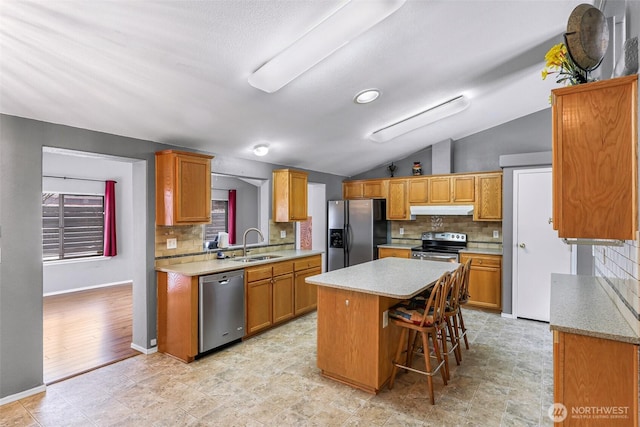 6350 Portal Way Unit 75, Ferndale, WA 98248 - kitchen featuring stainless steel appliances, under cabinet range hood, a sink, a center island, and tasteful backsplash