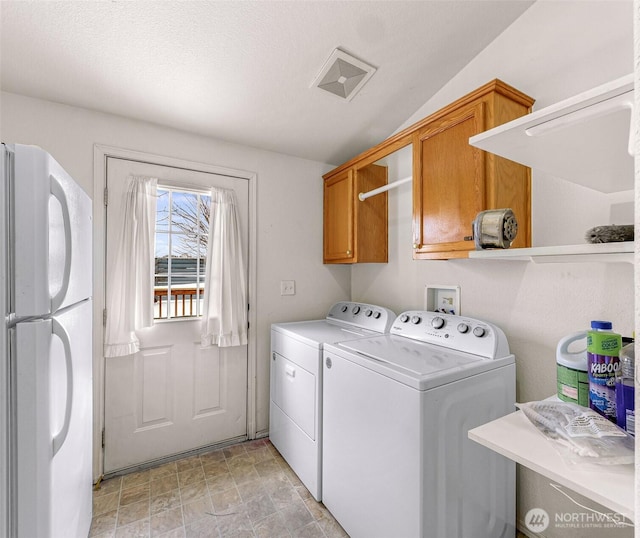 6350 Portal Way Unit 75, Ferndale, WA 98248 - washroom featuring washer and clothes dryer, cabinet space, and stone finish flooring