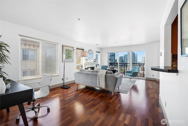 1711 E Olive Way Unit 519, Seattle, WA 98102 - living room featuring dark wood-type flooring, an office area, baseboards, and a view of skyline