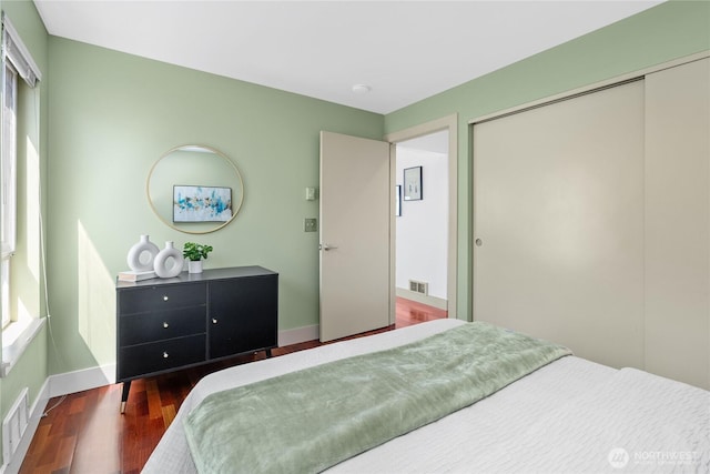 1711 E Olive Way Unit 519, Seattle, WA 98102 - bedroom featuring a closet, wood finished floors, and baseboards