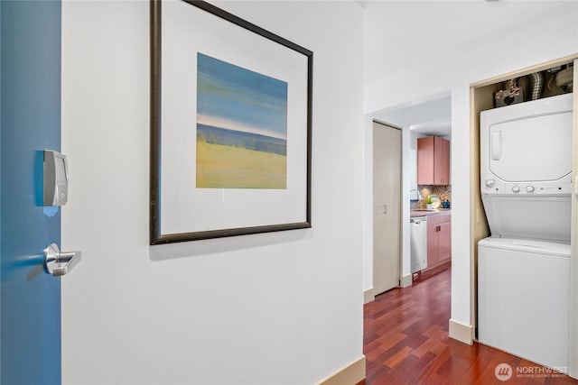 1711 E Olive Way Unit 519, Seattle, WA 98102 - hallway with stacked washing machine and dryer, dark wood-style floors, and a sink