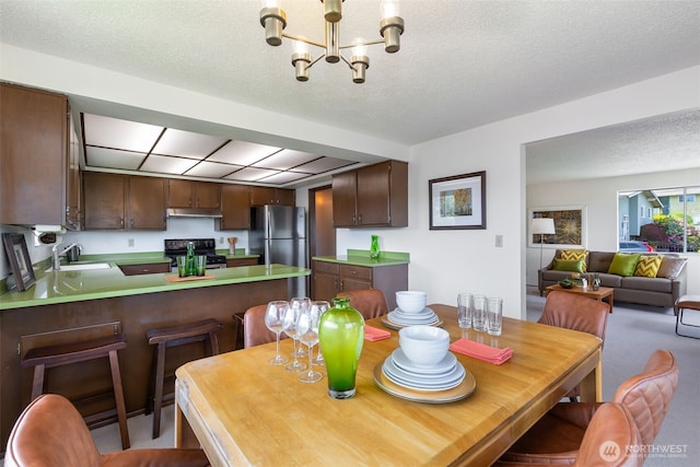 5228 56th Ave S, Seattle, WA 98118 - dining space with a chandelier and a textured ceiling