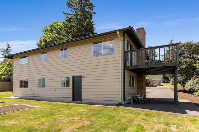 5228 56th Ave S, Seattle, WA 98118 - rear view of house featuring a patio, a lawn, a chimney, and a wooden deck