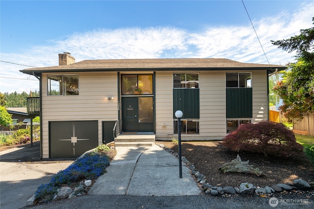 5228 56th Ave S, Seattle, WA 98118 - view of front of home with a chimney, asphalt driveway, and an attached garage