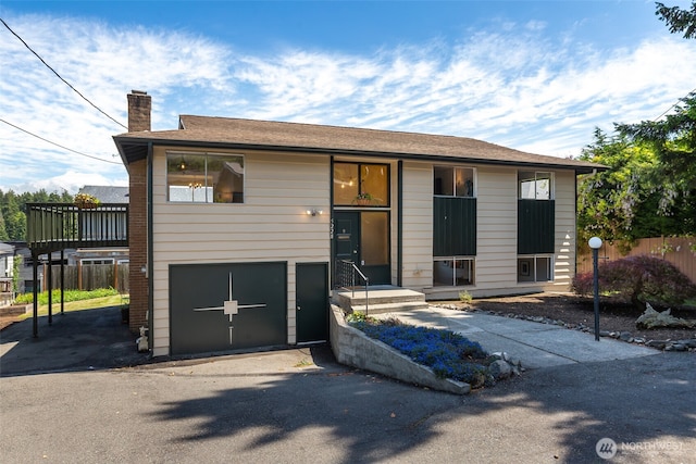 5228 56th Ave S, Seattle, WA 98118 - view of front of property with a chimney, an attached garage, and driveway
