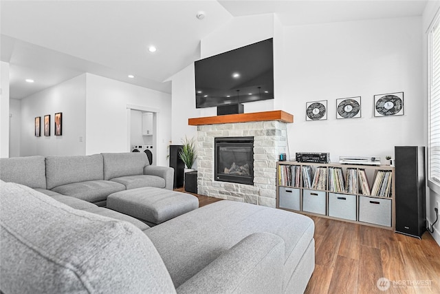 2016 Steelhead Way, Lynden, WA 98264 - living room with wood finished floors, washer / clothes dryer, a stone fireplace, recessed lighting, and high vaulted ceiling