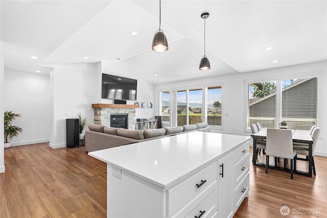 2016 Steelhead Way, Lynden, WA 98264 - kitchen with a fireplace, healthy amount of natural light, white cabinets, wood finished floors, and recessed lighting
