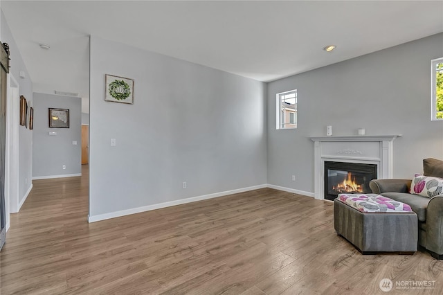 28140 239th Ave SE, Maple Valley, WA 98038 - living room with a glass covered fireplace, plenty of natural light, and wood finished floors