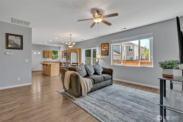 28140 239th Ave SE, Maple Valley, WA 98038 - living area featuring wood finished floors, a ceiling fan, a chandelier, and recessed lighting