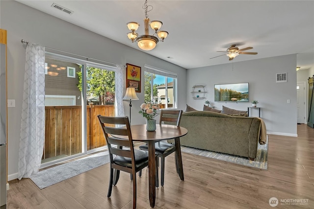 28140 239th Ave SE, Maple Valley, WA 98038 - dining room with wood finished floors, a chandelier, and ceiling fan