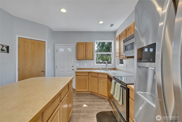 28140 239th Ave SE, Maple Valley, WA 98038 - kitchen featuring stainless steel appliances, light countertops, light wood-type flooring, and recessed lighting
