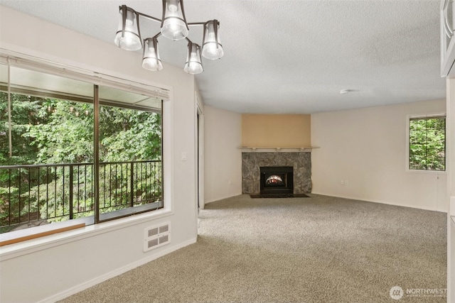 12515 NE 116th St Unit B23, Kirkland, WA 98034 - unfurnished living room with carpet floors, a textured ceiling, and a fireplace with flush hearth