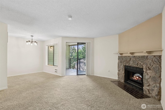 12515 NE 116th St Unit B23, Kirkland, WA 98034 - unfurnished living room featuring a stone fireplace, a textured ceiling, a chandelier, carpet flooring, and baseboards