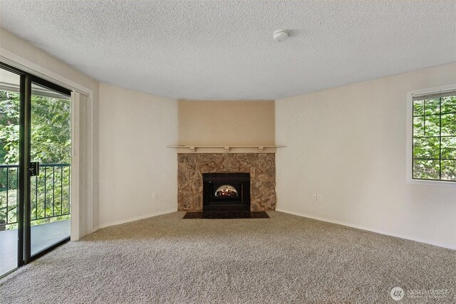 12515 NE 116th St Unit B23, Kirkland, WA 98034 - unfurnished living room featuring carpet floors, a fireplace with flush hearth, and a textured ceiling