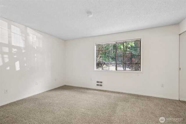 12515 NE 116th St Unit B23, Kirkland, WA 98034 - carpeted spare room featuring a textured ceiling, a smoke detector, and baseboards