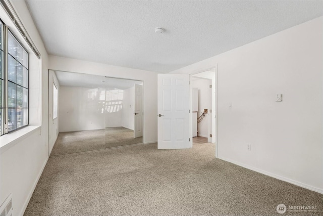 12515 NE 116th St Unit B23, Kirkland, WA 98034 - unfurnished room with carpet flooring, a textured ceiling, a smoke detector, and baseboards