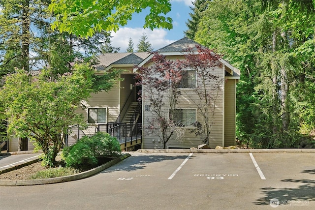 12515 NE 116th St Unit B23, Kirkland, WA 98034 - view of building exterior with stairs and uncovered parking