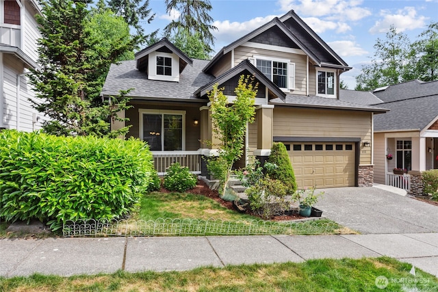 111 170th St SE, Bothell, WA 98012 - craftsman-style house featuring driveway, roof with shingles, covered porch, stone siding, and an attached garage