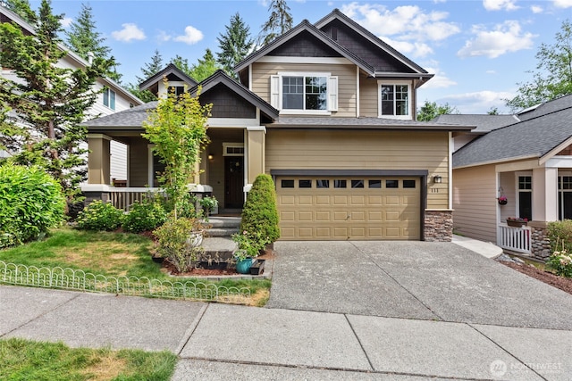 111 170th St SE, Bothell, WA 98012 - craftsman house featuring an attached garage, covered porch, driveway, and stone siding