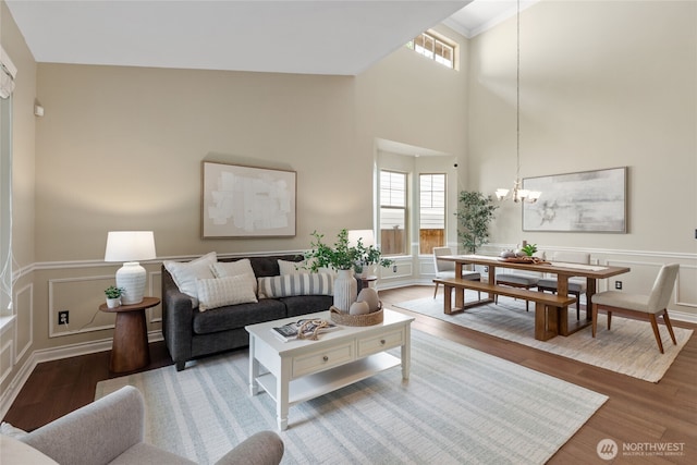 111 170th St SE, Bothell, WA 98012 - living area featuring a chandelier, wood finished floors, a decorative wall, healthy amount of natural light, and a high ceiling