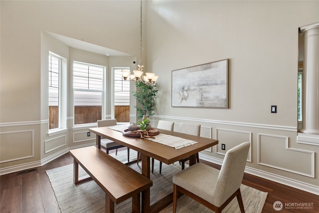 111 170th St SE, Bothell, WA 98012 - dining area with dark wood-style floors, a decorative wall, a wainscoted wall, and a chandelier