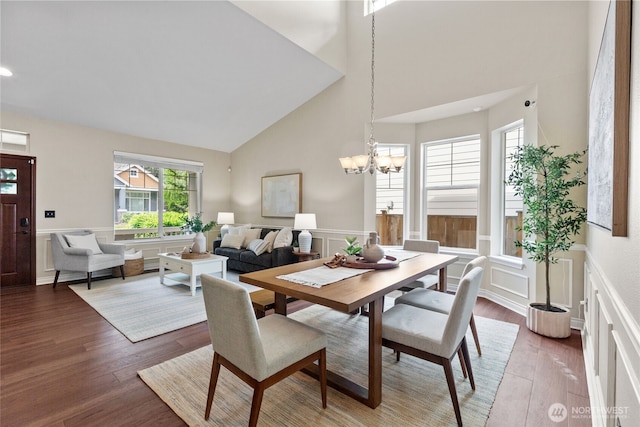 111 170th St SE, Bothell, WA 98012 - dining area with a high ceiling, a chandelier, wainscoting, wood finished floors, and a decorative wall