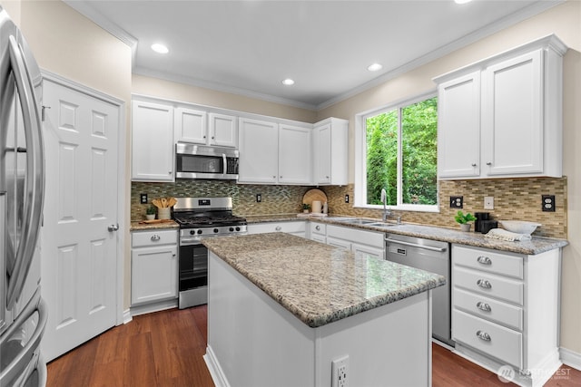 111 170th St SE, Bothell, WA 98012 - kitchen with appliances with stainless steel finishes, crown molding, dark wood-style floors, white cabinets, and a kitchen island