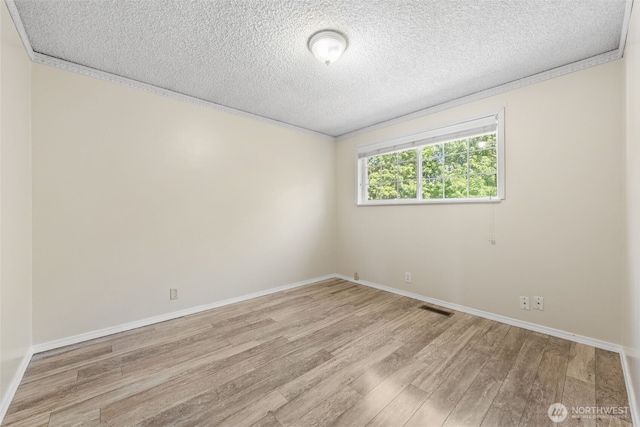 11401 69th Pl S, Seattle, WA 98178 - spare room featuring wood finished floors, a textured ceiling, baseboards, and crown molding